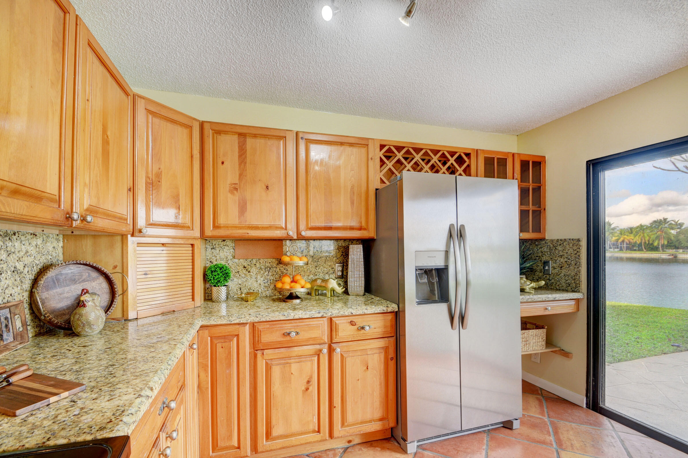 12561 Shoreside Lane Wellington, FL 33414 - Photo 4 of 31 a kitchen with stainless steel appliances granite countertop a refrigerator a stove and a sink with wooden floor