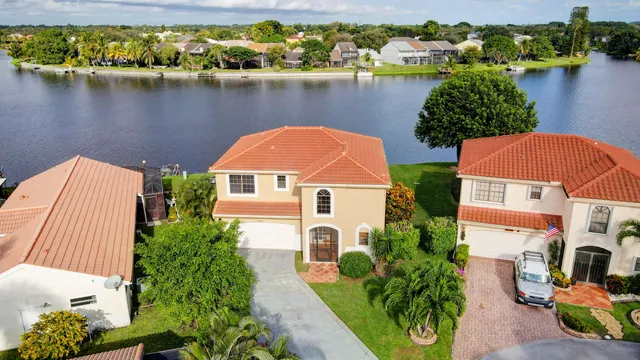 an aerial view of a house with a lake view