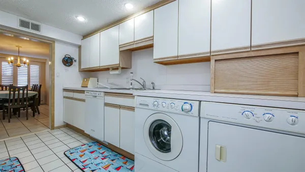 a living room with furniture a window and a potted plant