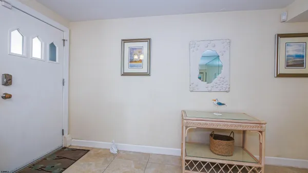 a dining room with furniture a chandelier and window