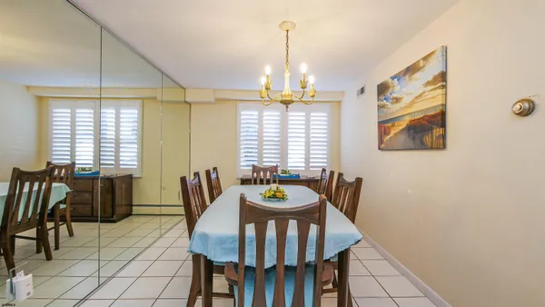 a view of a dining room with furniture and chandelier