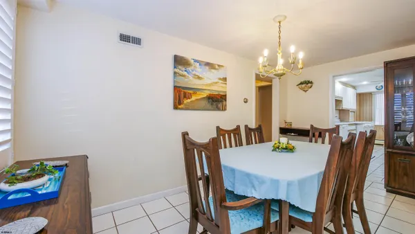 a view of a dining room with furniture and chandelier