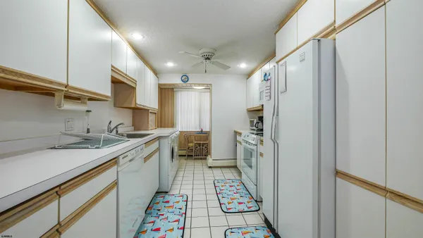 a utility room with sink dryer and washer