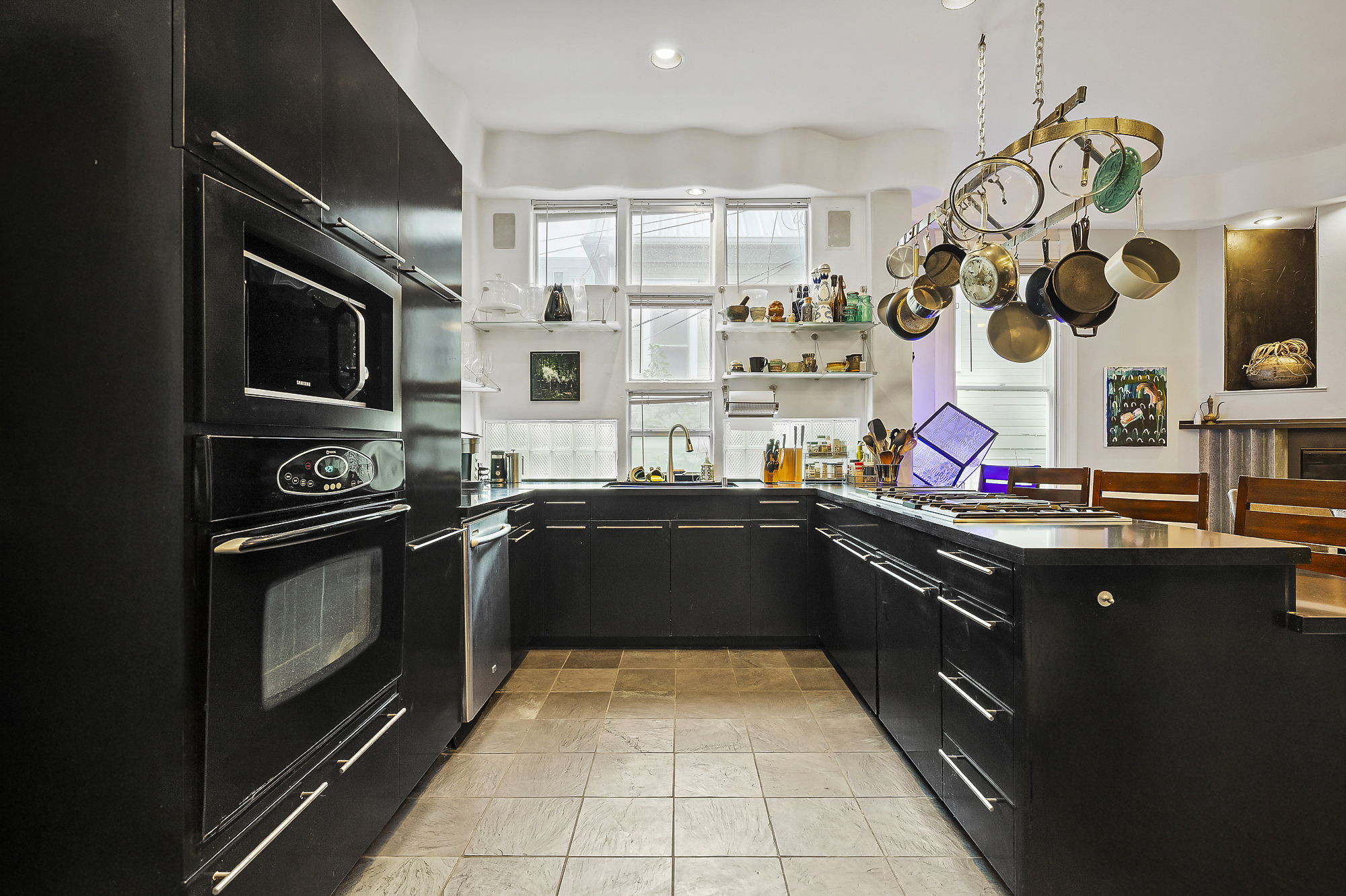 1007 East 8th Street Austin, TX 78702 - Photo 13 of 40 Kitchen with dark cabinets, a peninsula, black appliances, and recessed lighting