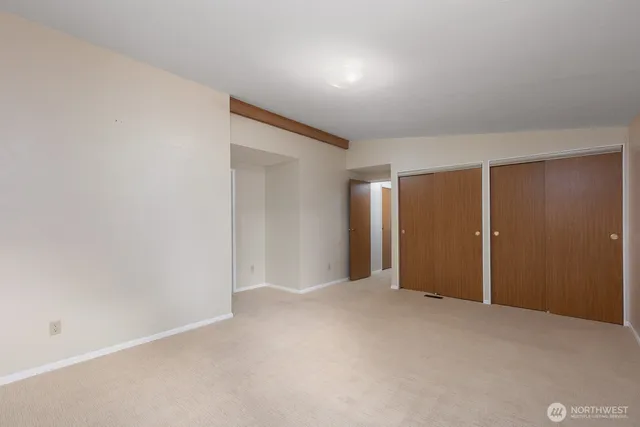 a bathroom with a toilet and a mirror