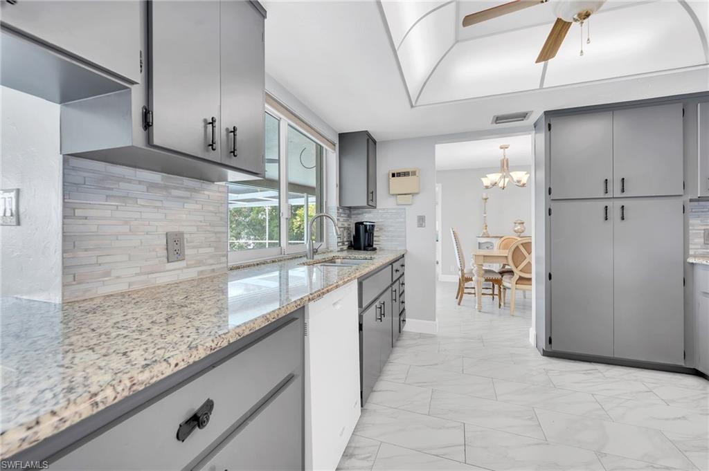 3065 50th Lane Southwest Naples, FL 34116 - Photo 9 of 31 a kitchen with stainless steel appliances granite countertop a sink and cabinets