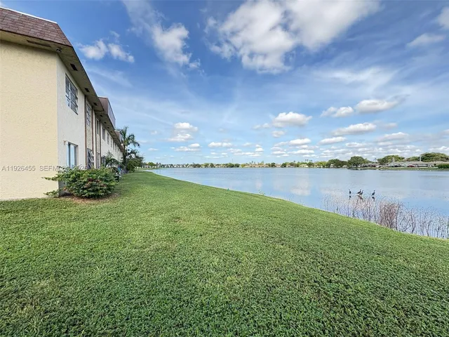 a view of a lake with houses in the back