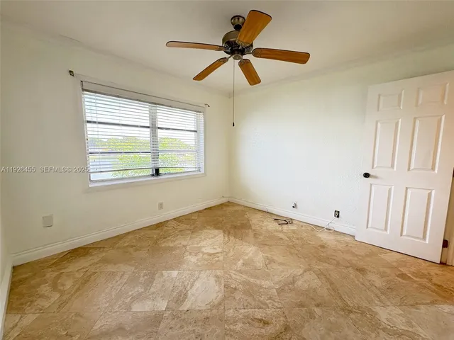 a view of an empty room and a window