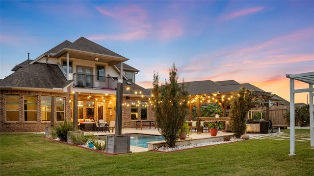 a front view of house with a garden and trees