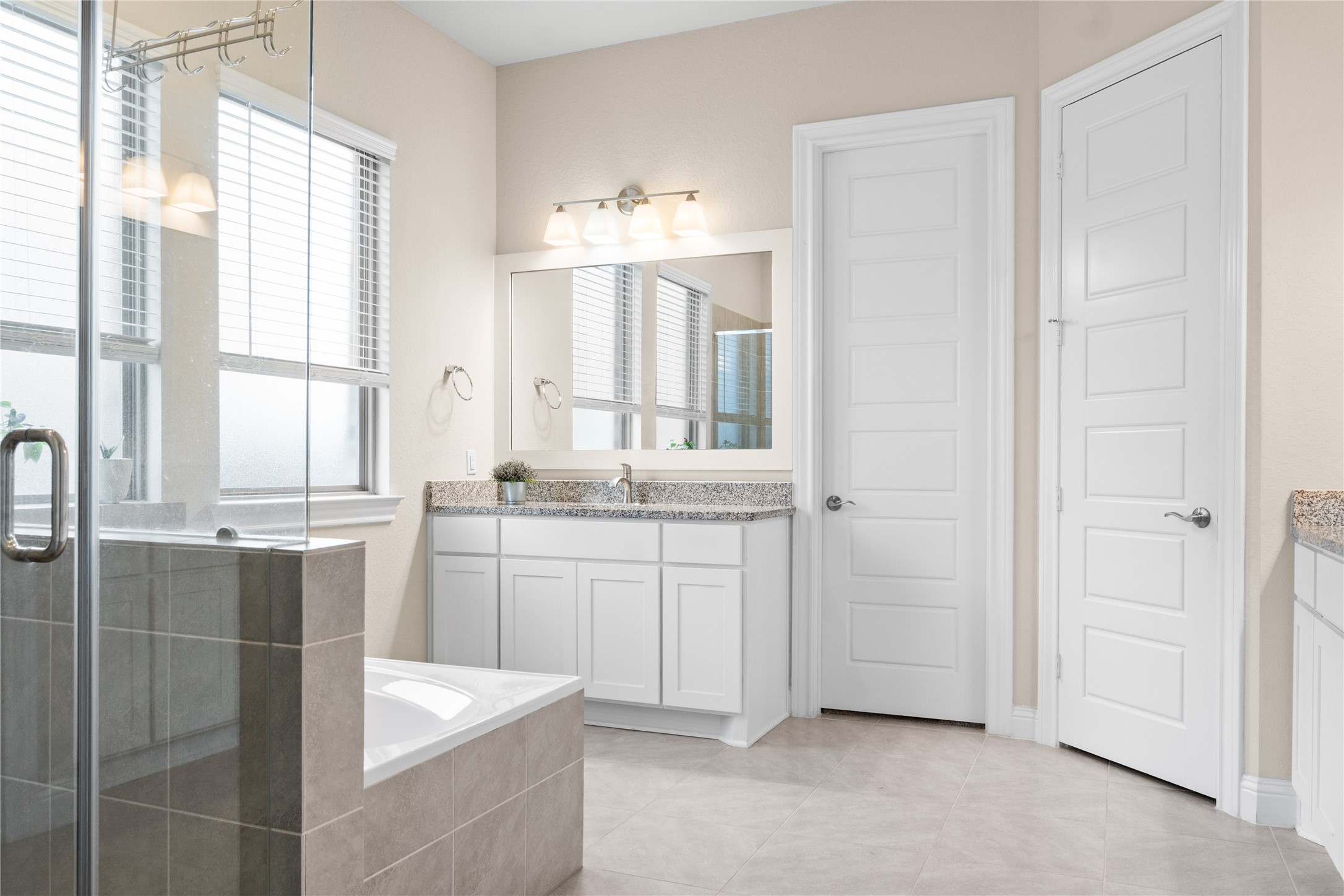 7518 Windsong Bend Road Spring, TX 77379 - Photo 24 of 49 a bathroom with a granite countertop sink and a mirror