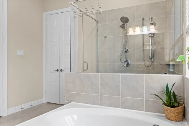 a en suite bathroom with a granite countertop sink and a mirror