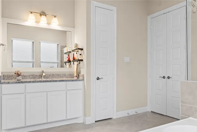 a white bath tub sitting next to a shower