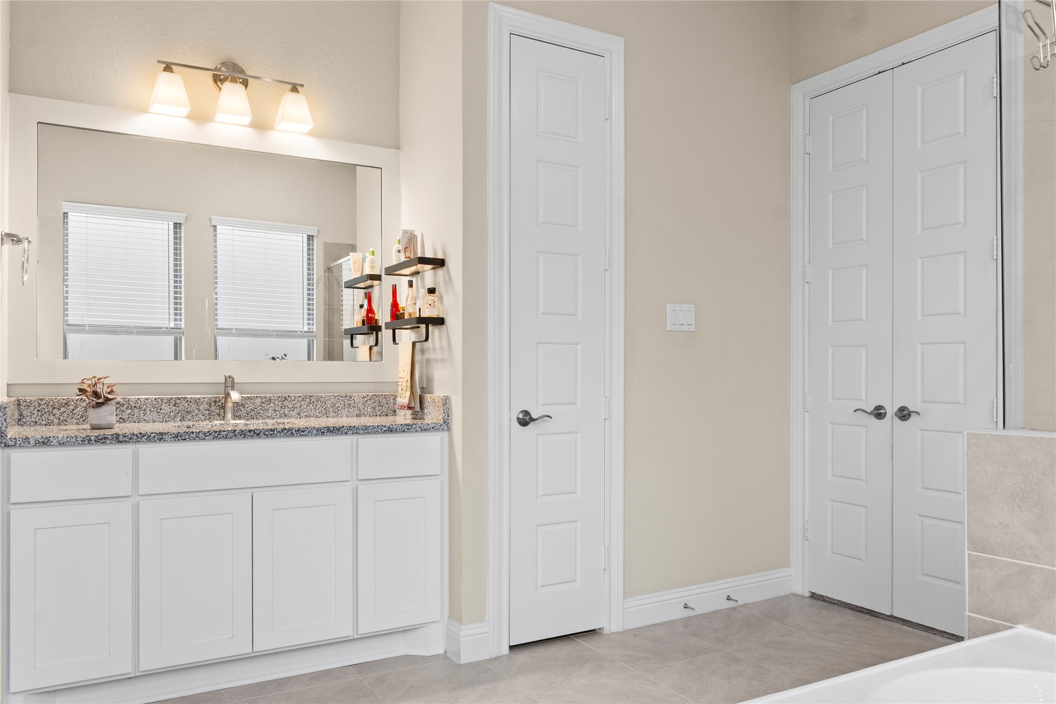 7518 Windsong Bend Road Spring, TX 77379 - Photo 27 of 49 a en suite bathroom with a granite countertop sink and a mirror