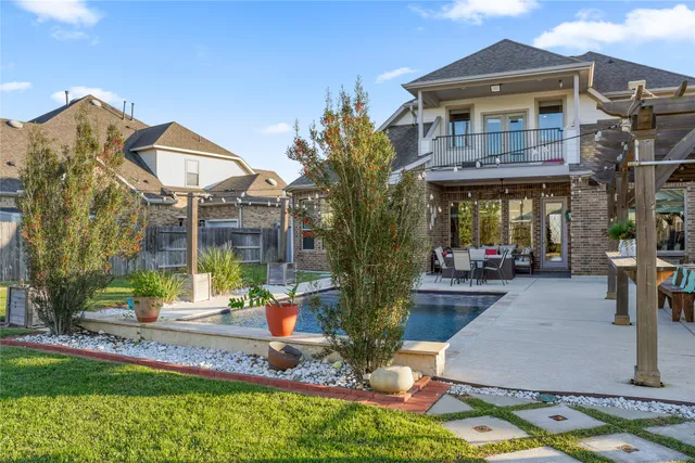 a front view of a house with swimming pool having outdoor seating