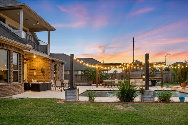 a swimming pool with outdoor seating and yard