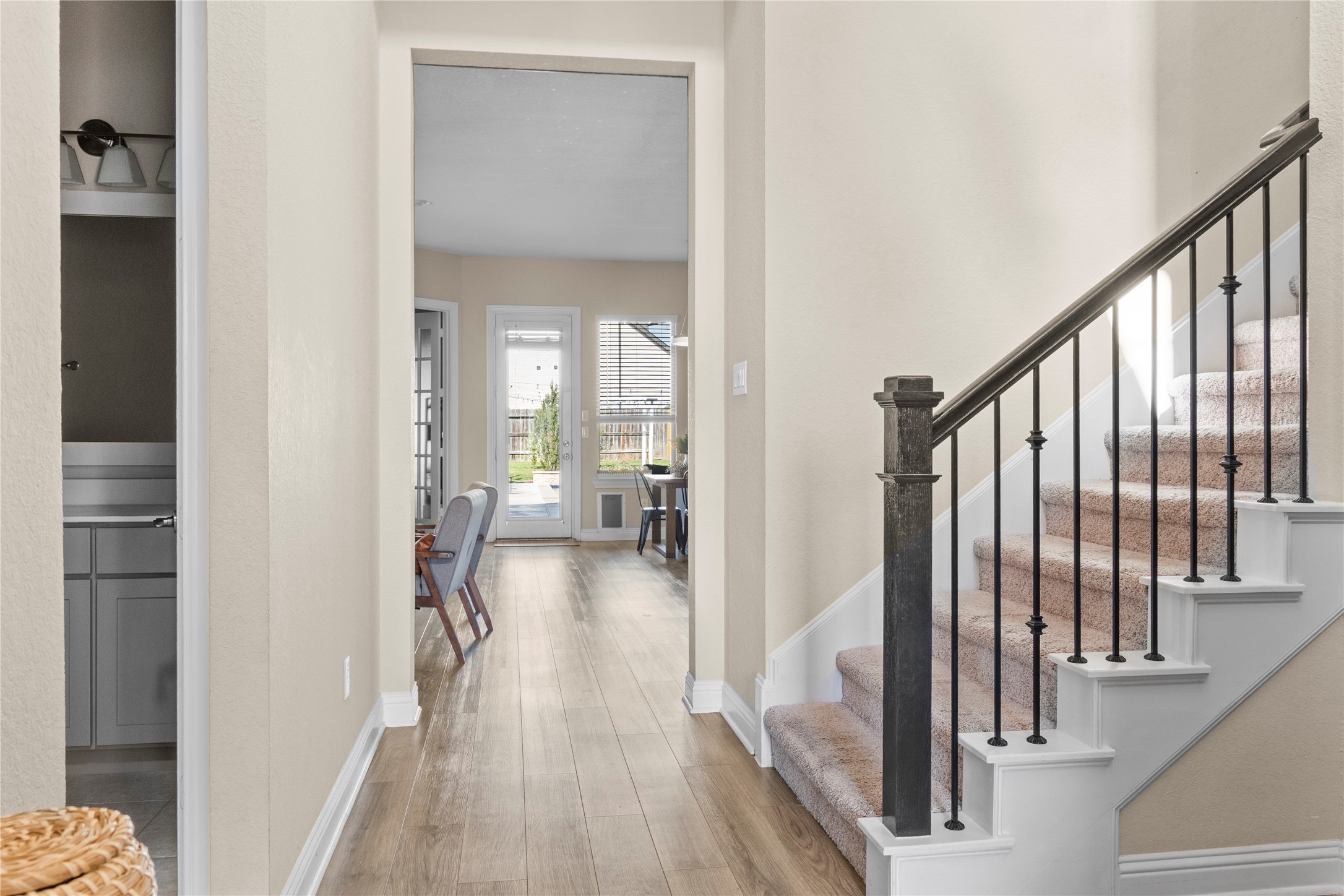7518 Windsong Bend Road Spring, TX 77379 - Photo 9 of 49 a view of a hallway with wooden floor and staircase