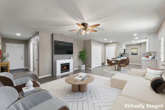a living room with furniture a fireplace and a flat screen tv