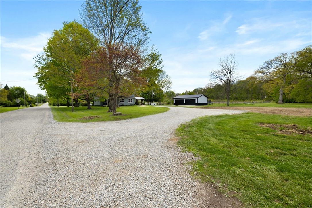 5120 Wheelock Road Troy, OH 45373 - Photo 54 of 67 This spacious property features a charming home, detached outbuilding, and expansive gravel driveway.
