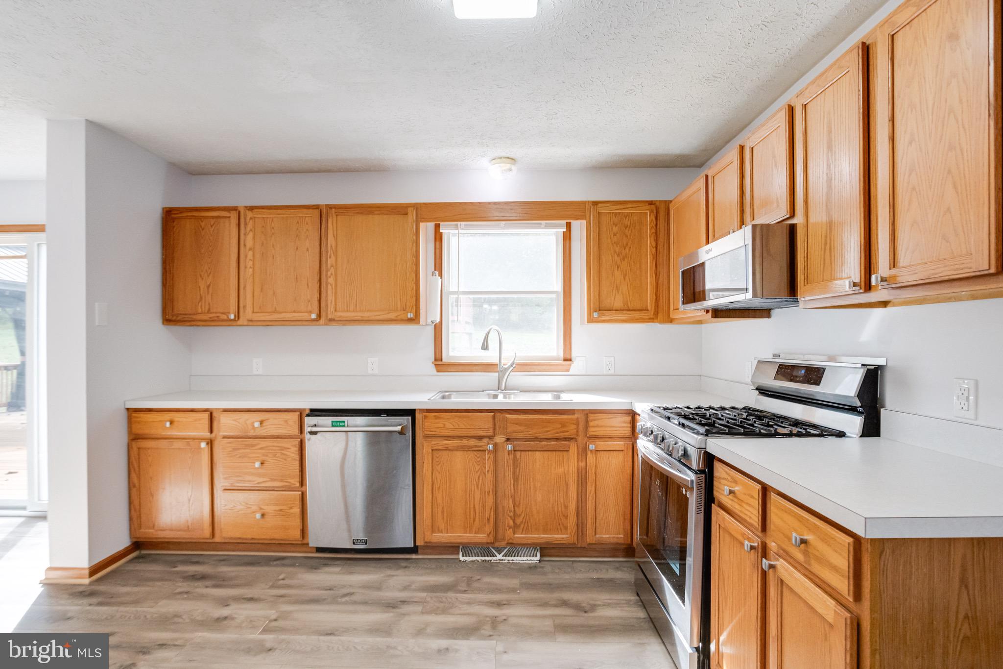 52 Craig Court Conowingo, MD 21918 - Photo 39 of 101 a kitchen with stainless steel appliances granite countertop a sink stove cabinets and wooden floor