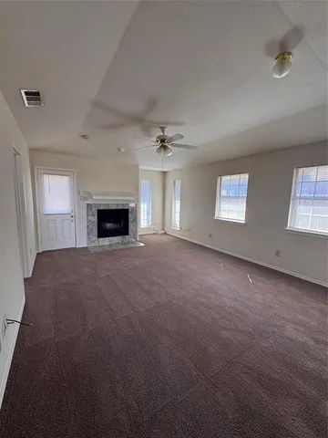 a view of empty room with a fireplace