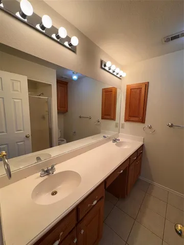 a bathroom with a sink double vanity and a mirror