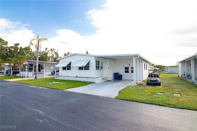 a front view of a house with a yard patio and swimming pool