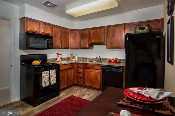 6 Knoll Ridge Court, Unit 1432 Baltimore, MD 21210 - Photo 11 of 20 a kitchen with a refrigerator stove and sink