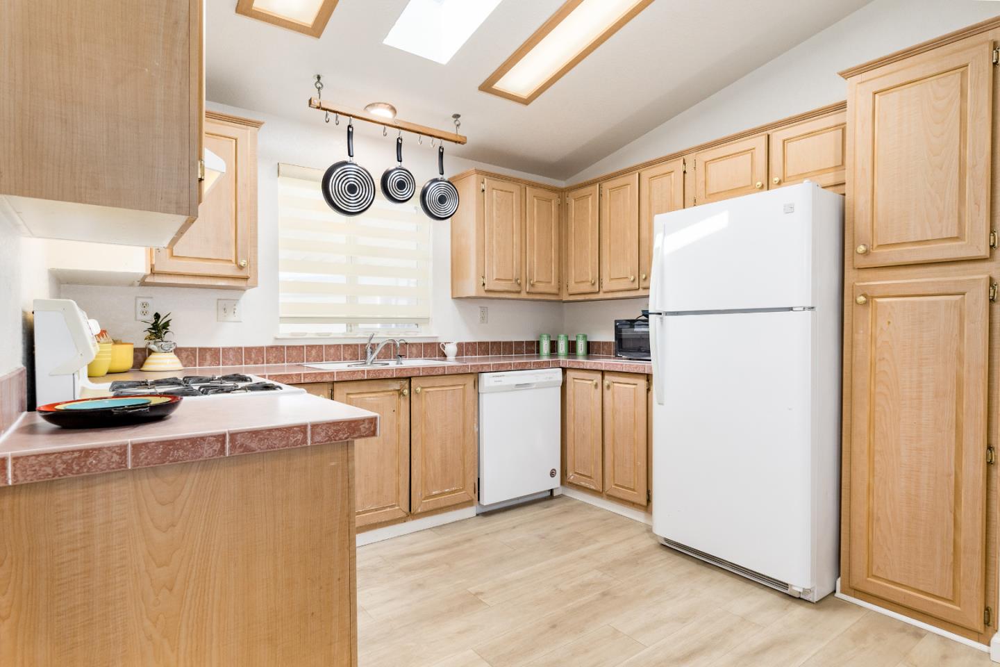 2546 Capitola Road, Unit 6 Santa Cruz, CA 95062 - Photo 11 of 40 a kitchen with a refrigerator a stove a microwave and cabinets