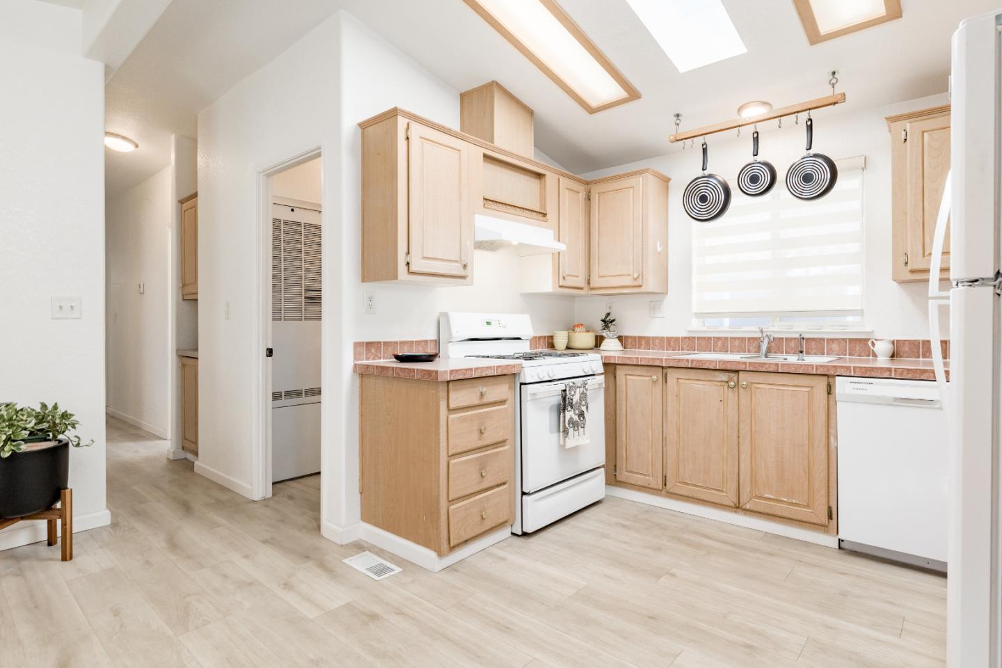 2546 Capitola Road, Unit 6 Santa Cruz, CA 95062 - Photo 12 of 40 a kitchen with white cabinets and white appliances