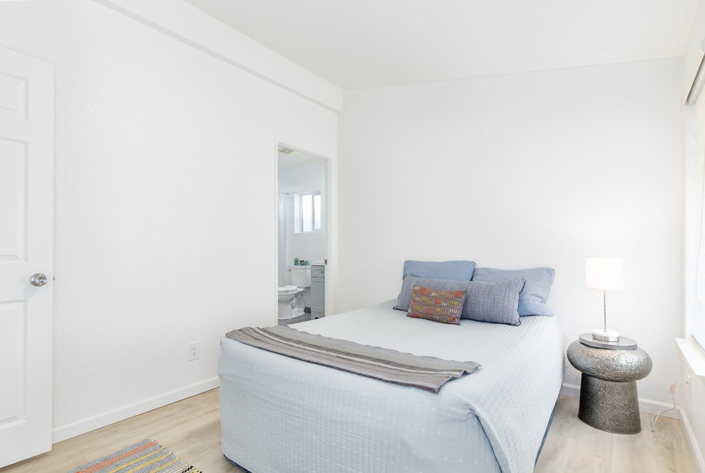 2546 Capitola Road, Unit 6 Santa Cruz, CA 95062 - Photo 16 of 40 a bedroom with a bed and white wall painting