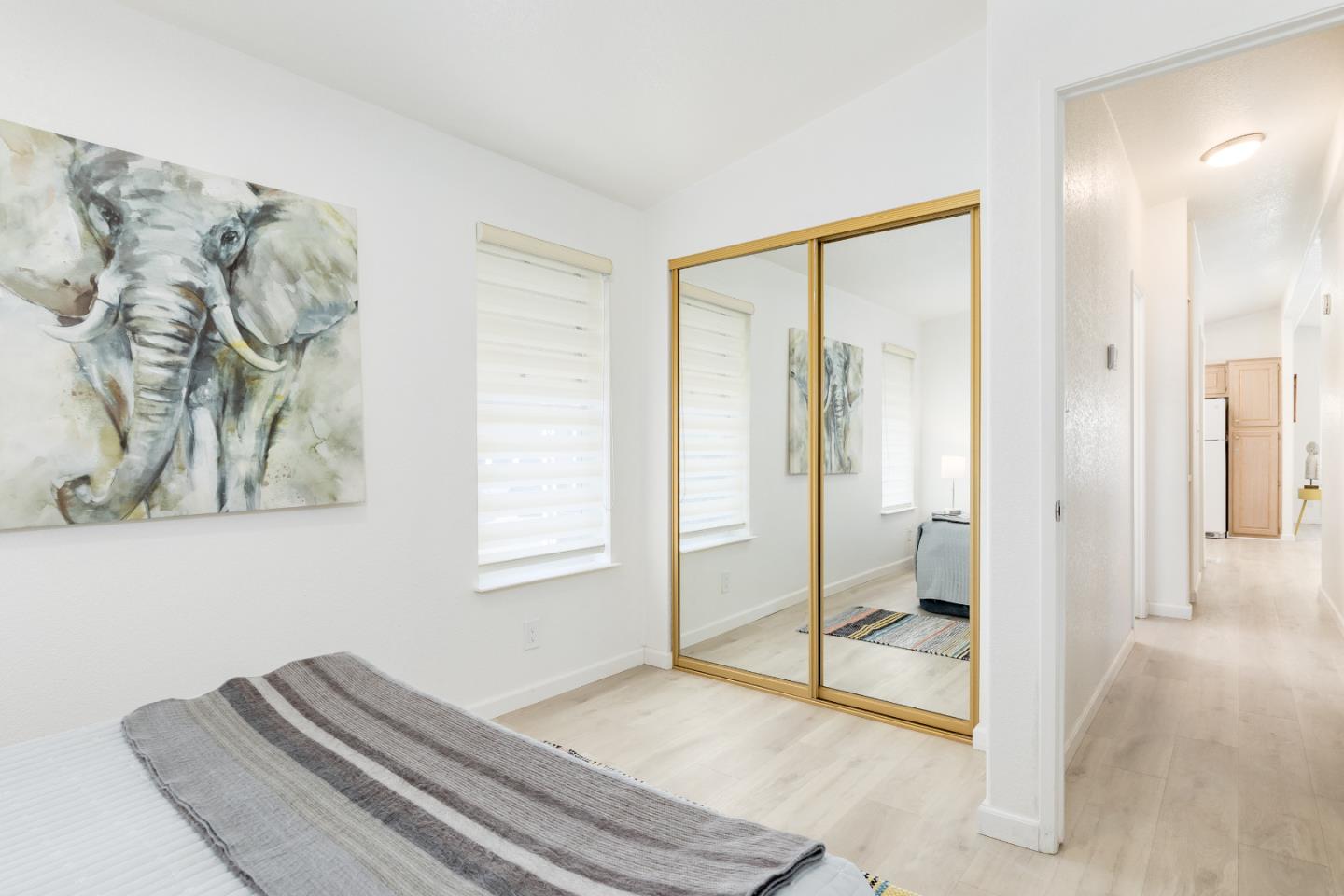 2546 Capitola Road, Unit 6 Santa Cruz, CA 95062 - Photo 17 of 40 a bedroom with a bed and a painting on the wall