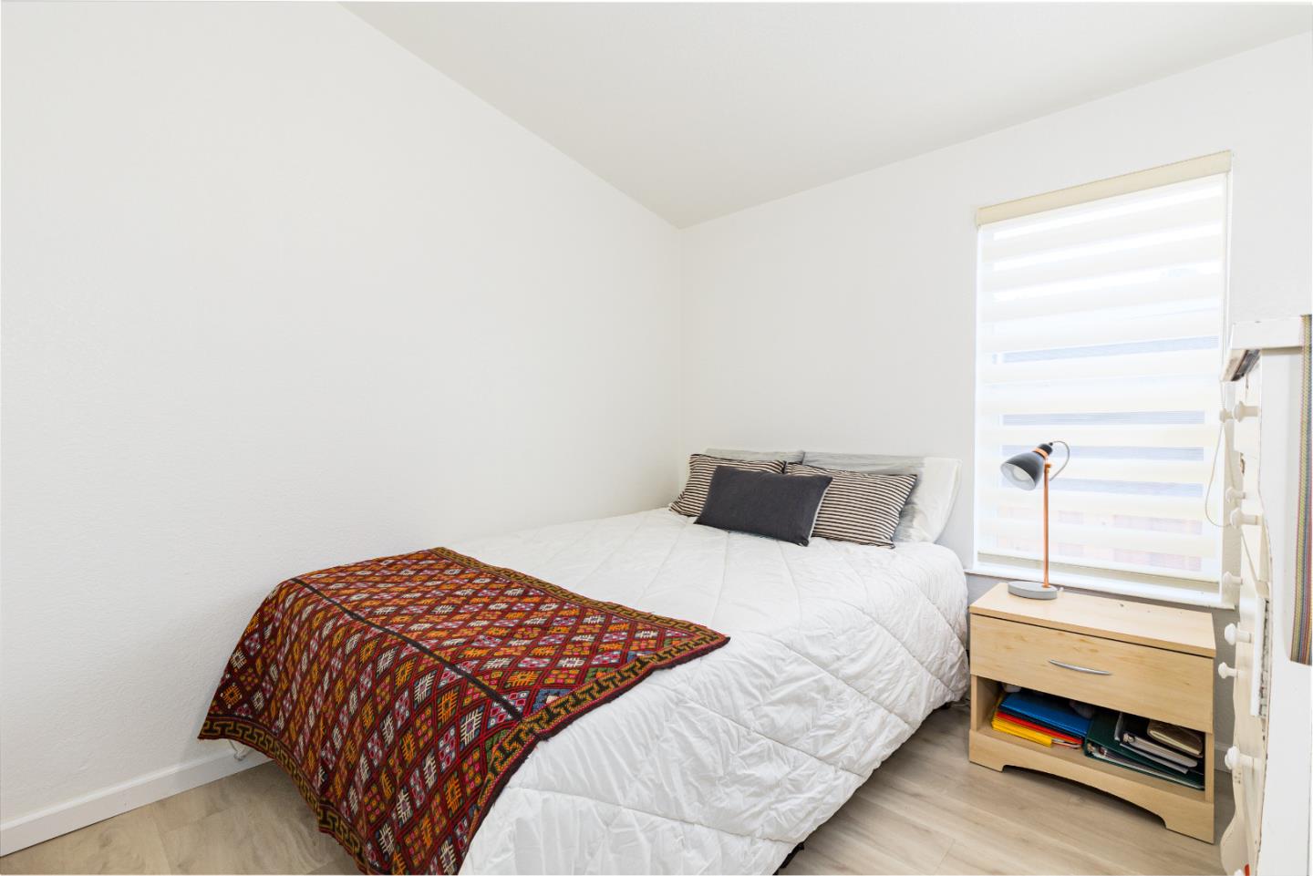 2546 Capitola Road, Unit 6 Santa Cruz, CA 95062 - Photo 23 of 40 a bedroom with a bed and a window