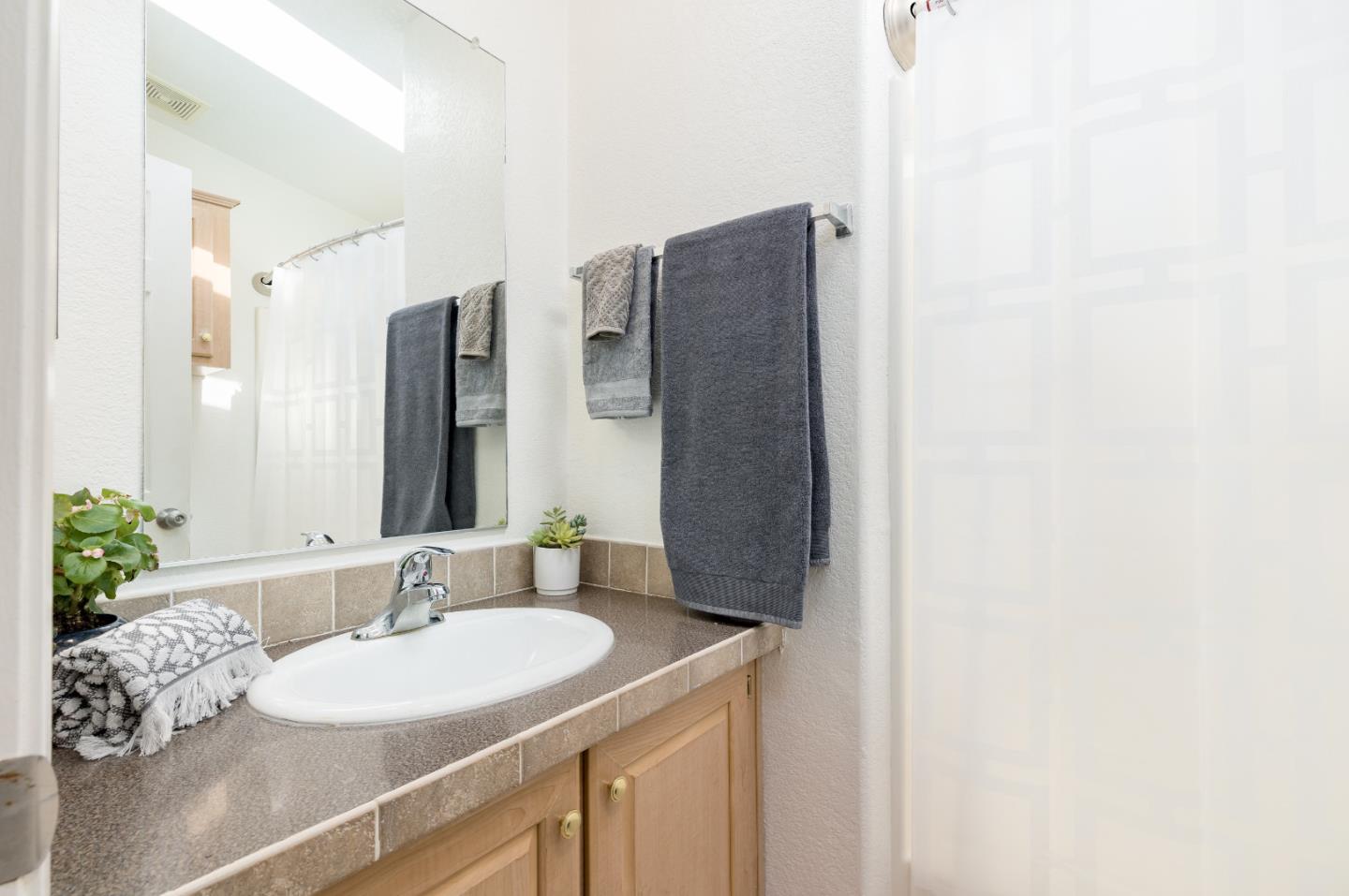2546 Capitola Road, Unit 6 Santa Cruz, CA 95062 - Photo 24 of 40 a bathroom with a sink and a mirror