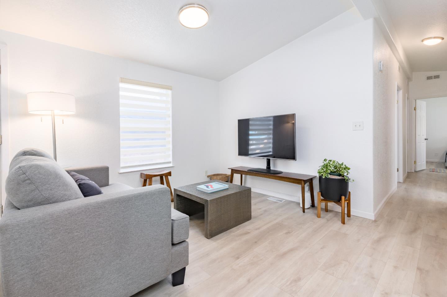 2546 Capitola Road, Unit 6 Santa Cruz, CA 95062 - Photo 5 of 40 a living room with furniture and a flat screen tv