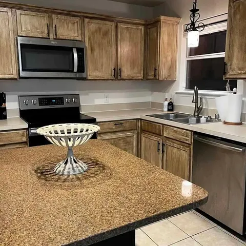 a kitchen with a sink and a microwave