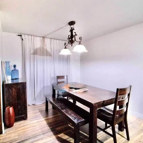 a large bed sitting in a bedroom next to a window