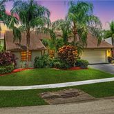 a view of a garden and palm trees