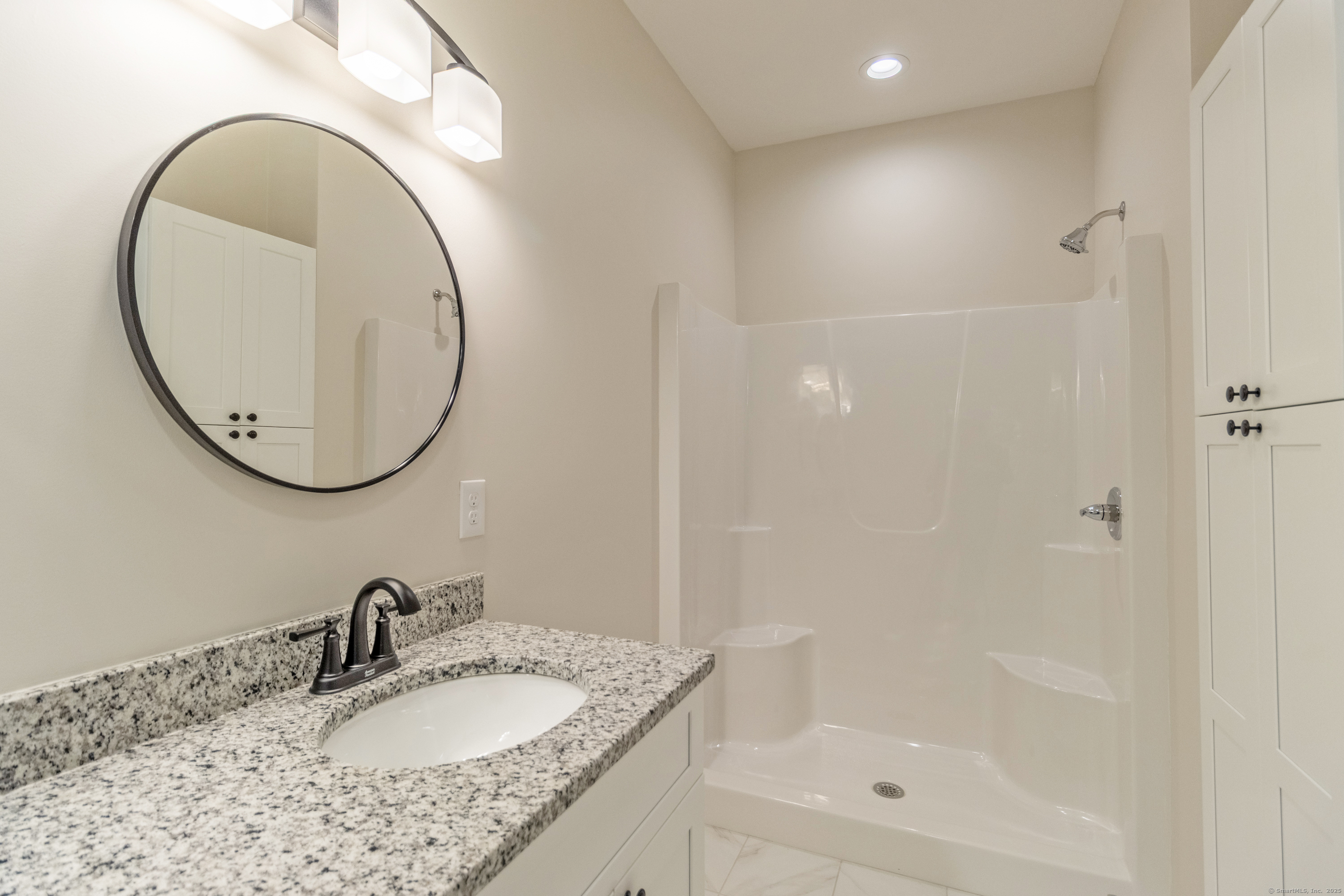 18 Spring Hill Road Storrs Mansfield, CT 06268 - Photo 16 of 31 a bathroom with a granite countertop sink a mirror and a shower