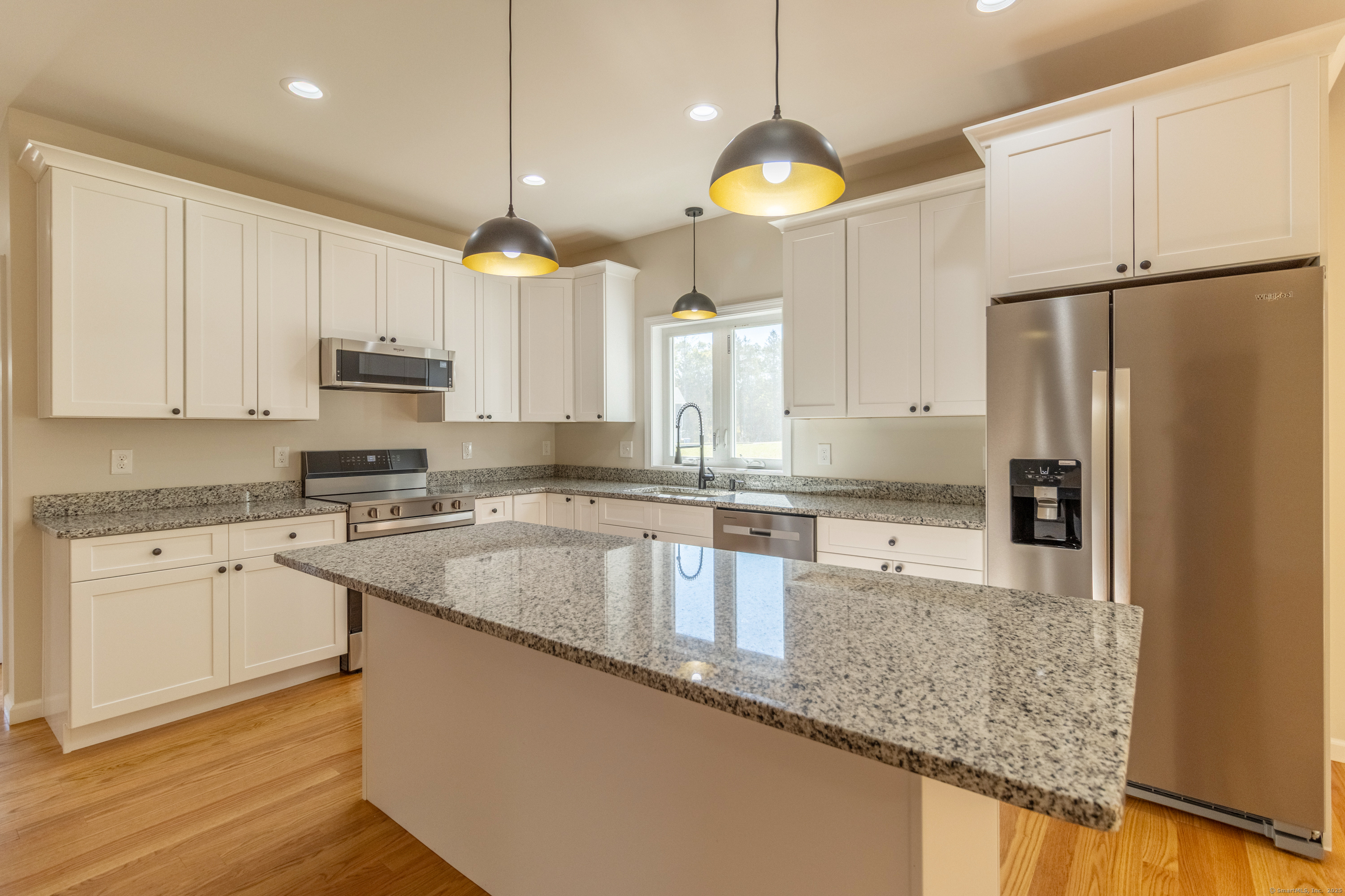 18 Spring Hill Road Storrs Mansfield, CT 06268 - Photo 2 of 31 a kitchen with stainless steel appliances granite countertop a sink a stove a refrigerator a center island and cabinets