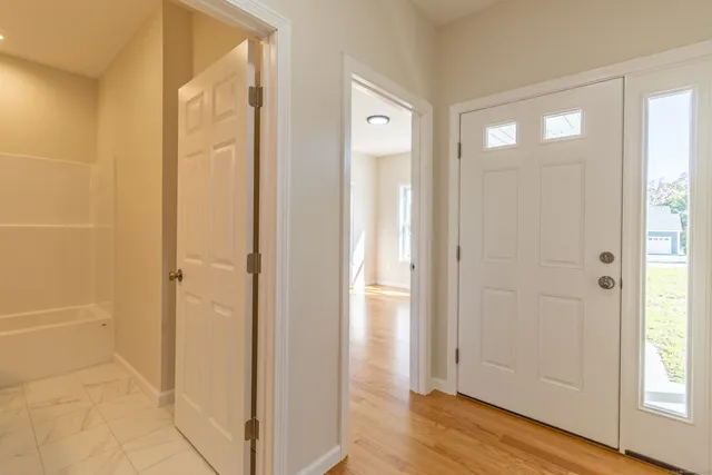 a view of a bathroom with wooden floor and windows