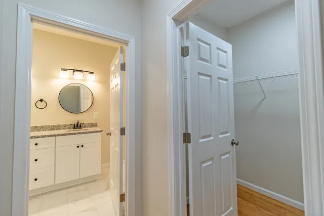 a bathroom with a granite countertop sink vanity mirror and a mirror