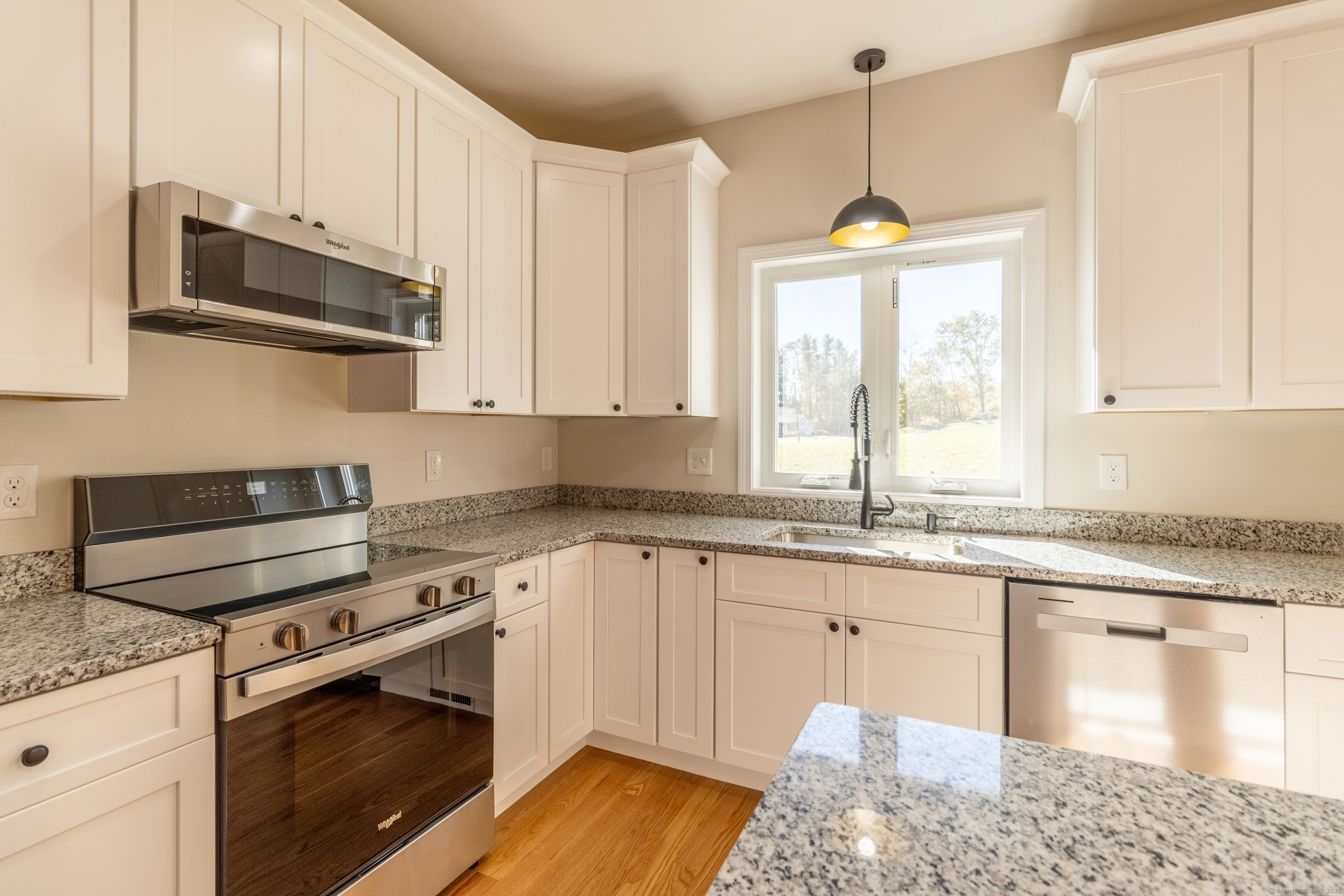 18 Spring Hill Road Storrs Mansfield, CT 06268 - Photo 8 of 31 a kitchen with stainless steel appliances granite countertop a stove a sink and a microwave