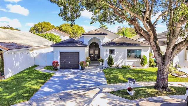 a front view of a house with garden and porch