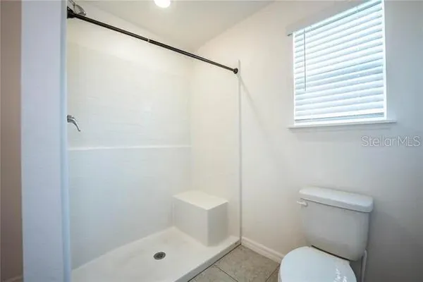 a bathroom with a shower and a toilet