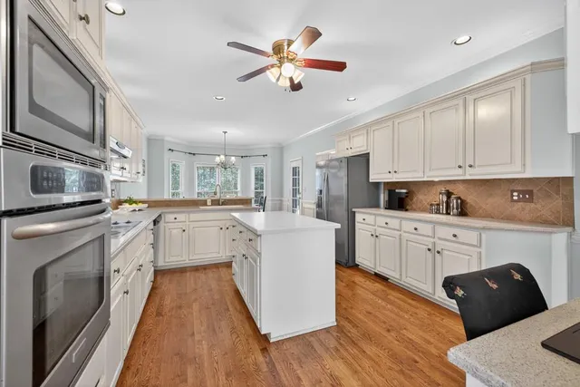 a view of a dining room with furniture wooden floor and chandelier