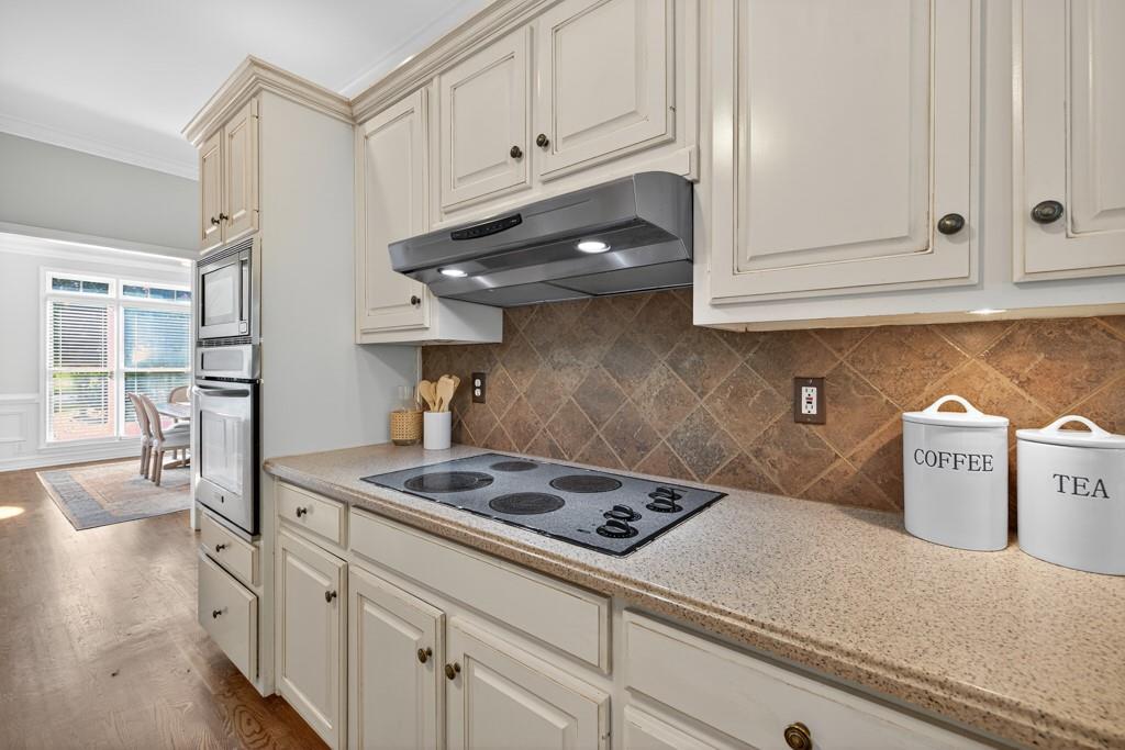 1430 Roanoke Trace Grayson, GA 30017 - Photo 13 of 62 a kitchen with a stove and cabinets