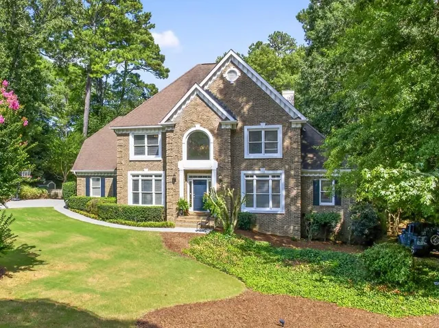 a front view of a house with a yard