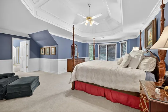 a bedroom with bed and a chandelier