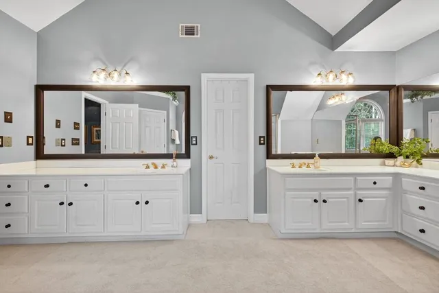 a bathroom with a sink a toilet and vanity