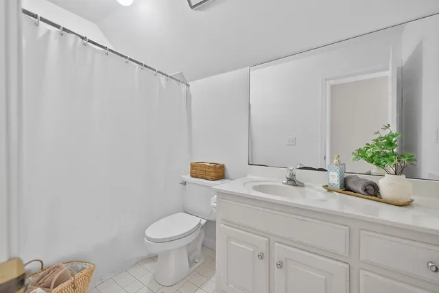 a bedroom with a bed a table and gym equipment